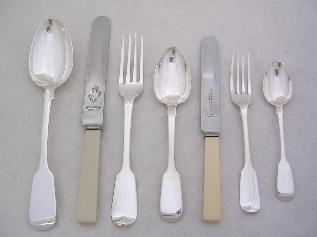 A selection of silverware, some with cream handles.